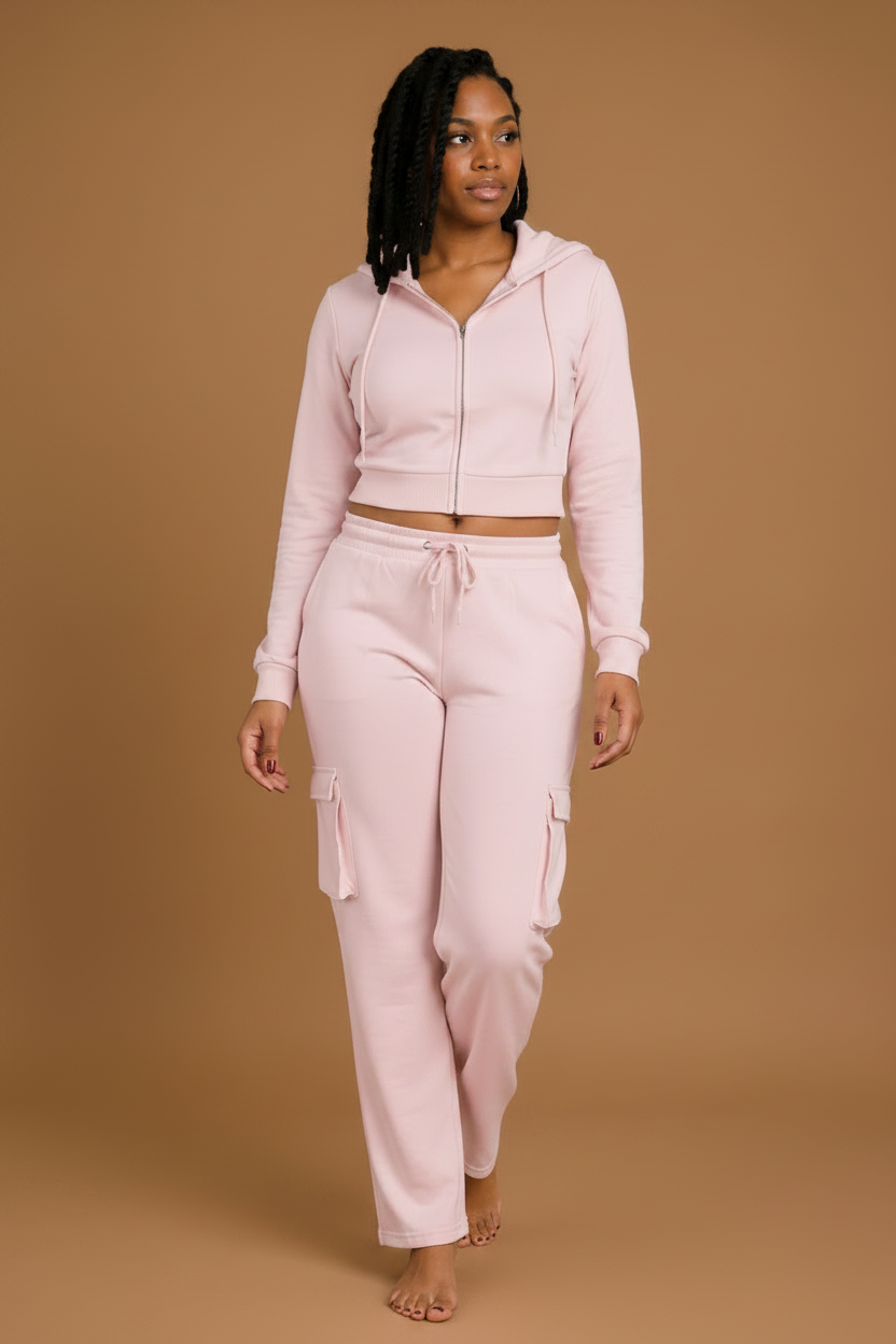 Woman wearing a pink tracksuit against a brown background